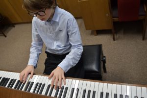 Child taking music exam on piano