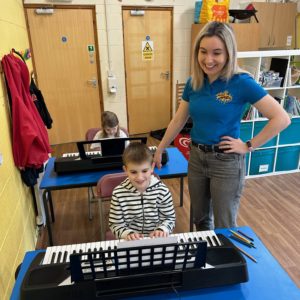 Music Teacher in classroom with student